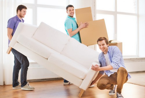 Removal van and moving boxes outside a home in Addington